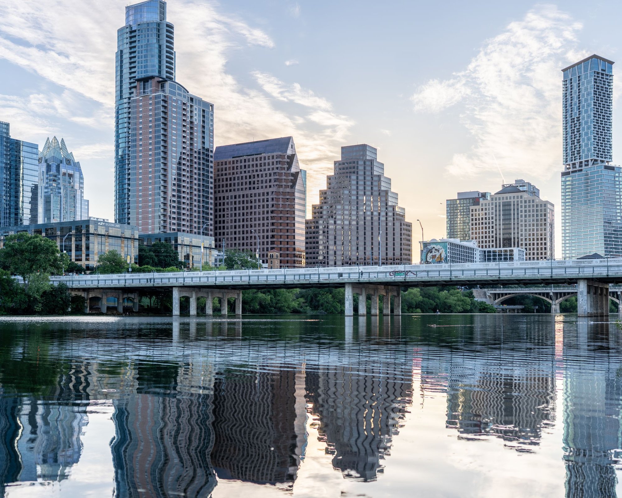 Austin, Texas skyline reflected in Lady Bird Lake at sunrise