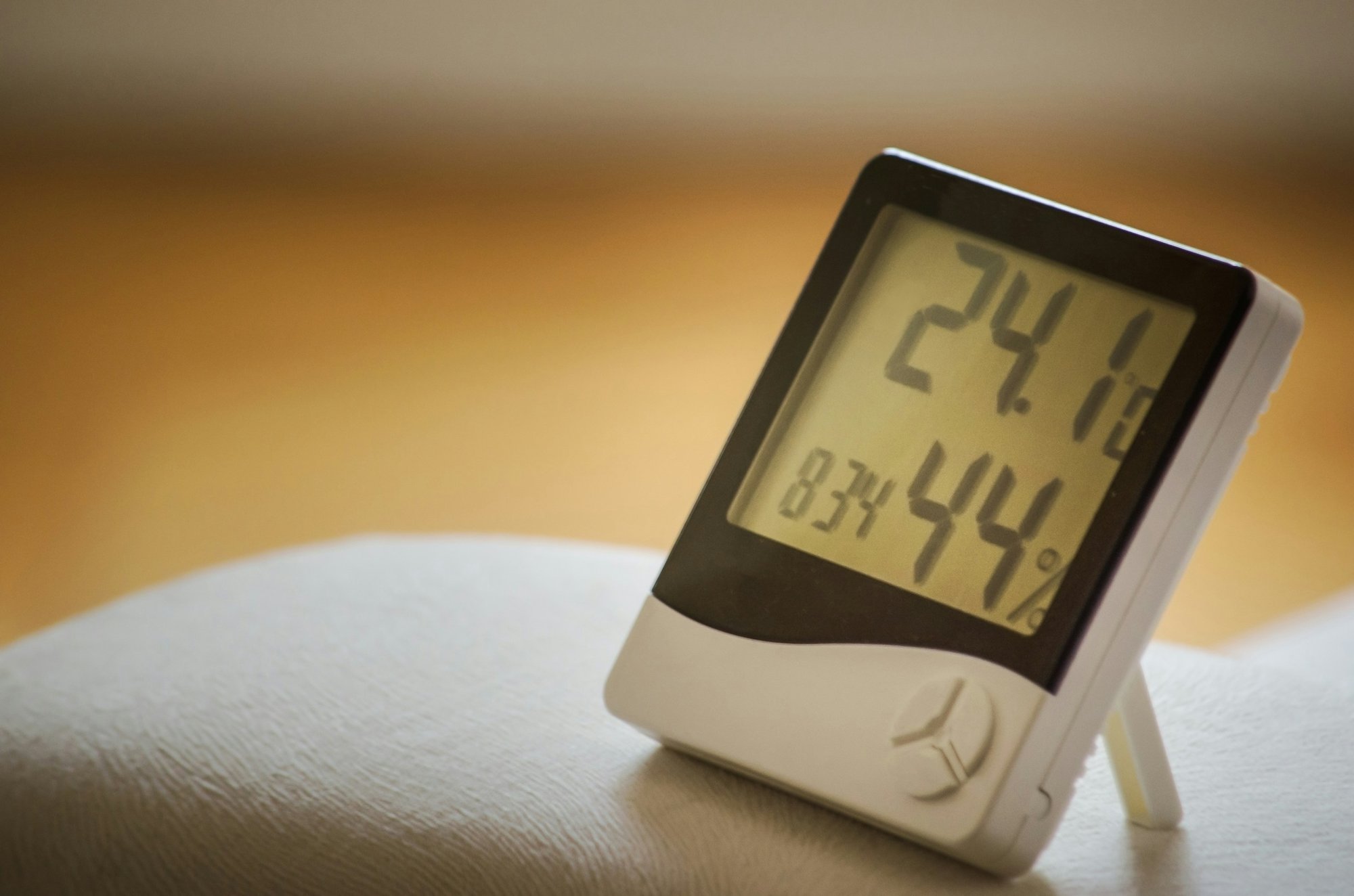 Digital hygrometer showing indoor temperature and 44 percent humidity